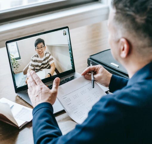 Image of a man in a video meeting on a laptop.