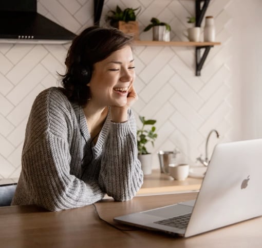 Image of a woman in a videocall on a laptop.