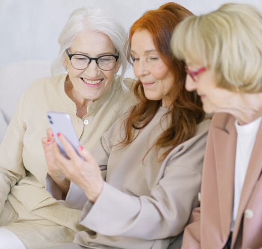 Image of 3 women videochatting on a phone.